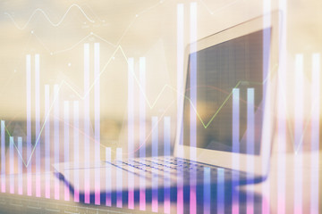 Forex Chart hologram on table with computer background. Multi exposure. Concept of financial markets.