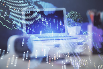 Stock market graph on background with desk and personal computer. Multi exposure. Concept of financial analysis.
