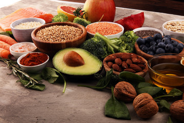Healthy food clean eating selection: fish, fruit, vegetable, cereal, leaf vegetable on rustic background