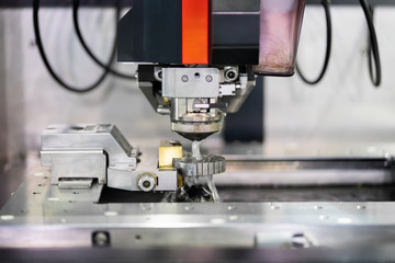 High precision CNC wire cut machine working, operator machining die metal mold process in the factory