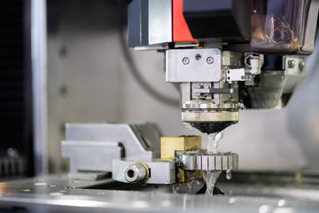 High precision CNC wire cut machine working, operator machining die metal mold process in the factory