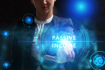 Business, Technology, Internet and network concept. Young businessman working on a virtual screen of the future and sees the inscription: Passive income