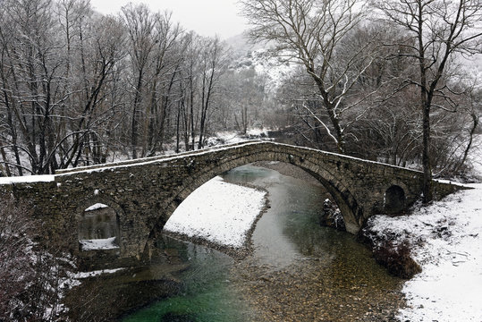 View of the traditional stone Bridge of Kamber Agas in Epirus, Greece in winter