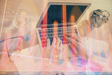 Multi exposure of forex graph with man working on computer on background. Concept of market analysis.