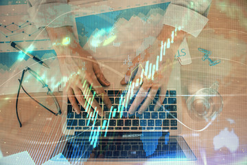 Double exposure of market chart with man working on computer on background. Concept of financial analysis.