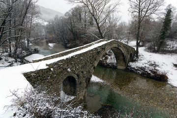 View of the traditional stone Bridge of Kamber Agas in Epirus, Greece in winter