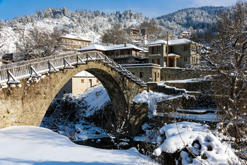 View of the traditional stone bridge in Vovousa village in Epirus, Greece in winter