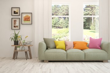 Fototapeta premium Stylish room in white color with sofa and summer landscape in window. Scandinavian interior design. 3D illustration