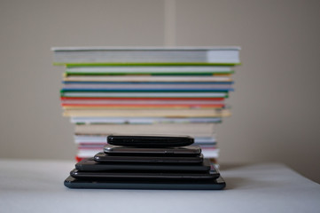 stack of books and gadgets on the table