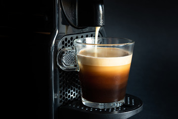 Hot coffee from a coffee machine.