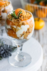 Citrus trifle with fresh tangerines. Christmas portioned dessert on the festive table.