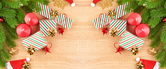 Christmas background with fir branches, various Christmas decorations, colored garlands and beads, on a light wood background. Christmas decorations. Christmas background. Space for text.