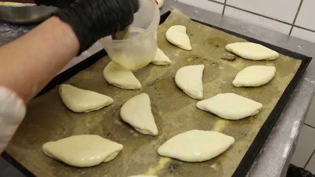 cook in the culinary shop makes dough rolls pies and pretzels