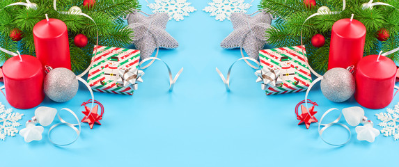 Christmas background with fir branches, various christmas decorations, colored garlands and beads, on a blue background. Christmas decoration. Christmas background. Space for text.