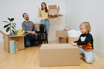 Cheerful young family exited about moving into a new home