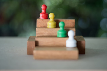 Chess pawn on a toy wooden ladder. Concept to symbolize achievement,