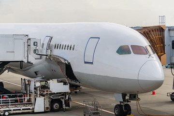 The plane that is waiting to pick up passengers at the airport