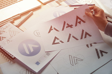 Graphic designer drawing sketch design creative Ideas draft Logo product trademark label brand...
