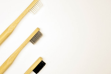 Black and white bamboo toothbrush on white background. Tooth care hygiene. 