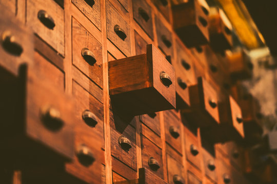 Old wooden textured drawers background in chinese herbal medicine shop in china.Vintage asian objects.