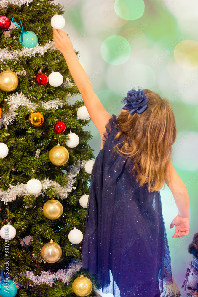 Sticker beautiful little girl decorating the Christmas tree