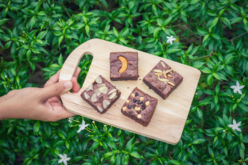 Fudge brownies on wooden plate and top view