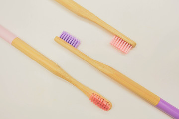Close up bamboo toothbrushes lay on white background. Zero waste 