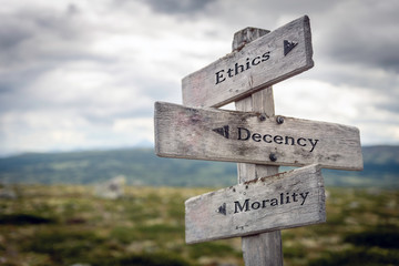 Ethics, decency and morality text on wooden sign post outdoors in landscape scenery. Business,...