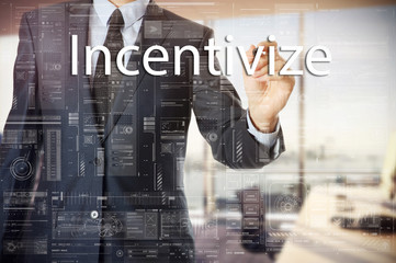 Fototapeta na wymiar businessman writes a popular buzzword on a virtual whiteboard: Incentivize.