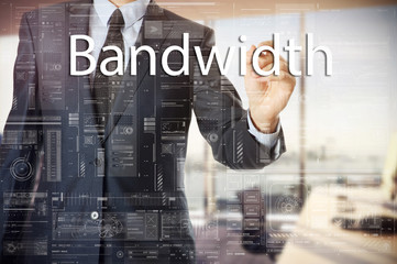 Fototapeta na wymiar businessman writes a popular buzzword on a virtual whiteboard: Bandwidth.