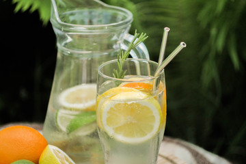 Close up preparing ice cocktail lemonade at hot summer day. Metal straw. Eco friendly picnic on  meadow.  Reusable 