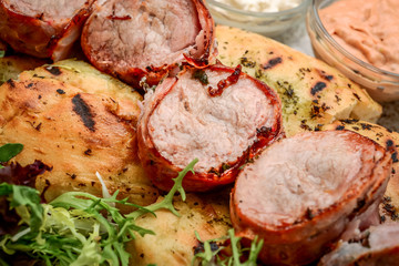Grilled meat skewers on a wooden background