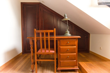 Vintage hazel office desk with a chair and a vintage lamp