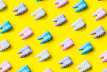 Teeth pattern on yellow bright background. Top view. Close up. Minimal dental care concept.