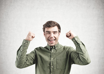 Fototapeta premium Happy smart casual man screaming, concrete