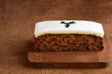 Fototapeta premium christmas fruitcake with holly decoration