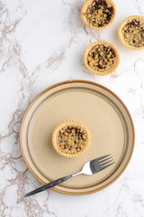 top view fruit crumble tart with a fork
