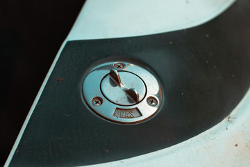 Chrome fuel tank cap. Fuel cap on a gray boat. Metallic gas tank cap
