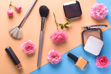 Flat view of cosmetics - lipstic, face-powder, brushes, nail polish