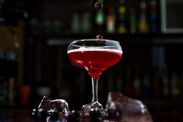 falling berries in a cocktail at the bar