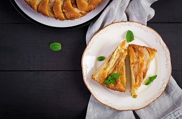 Homemade pie with pears and almond flour  on dark background. Top view, overhead