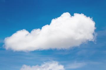 big white fluffy cloud in blue sky in clear sunshine day