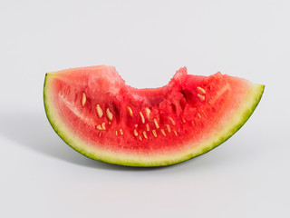 Bitten slice of watermelon on white background.