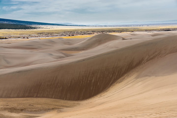 Fototapeta na wymiar Sand dunes on a background of dry valley.