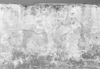 Weathered and cracked plastered concrete wall with mold. Plastering is partly peeled off. High resolution full frame textured background in black and white.