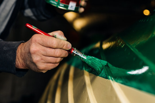 Painting a boat in green colour