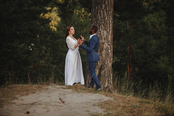 beautiful mixed couple of newlyweds