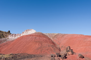 Landscape of barren red stone hillsides at the Painted Hills in Petrified Forest National Park in Arizona