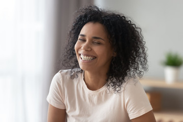 Excited African American woman with wide healthy smile close up