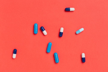 Colorful medicine capsules on a single color background